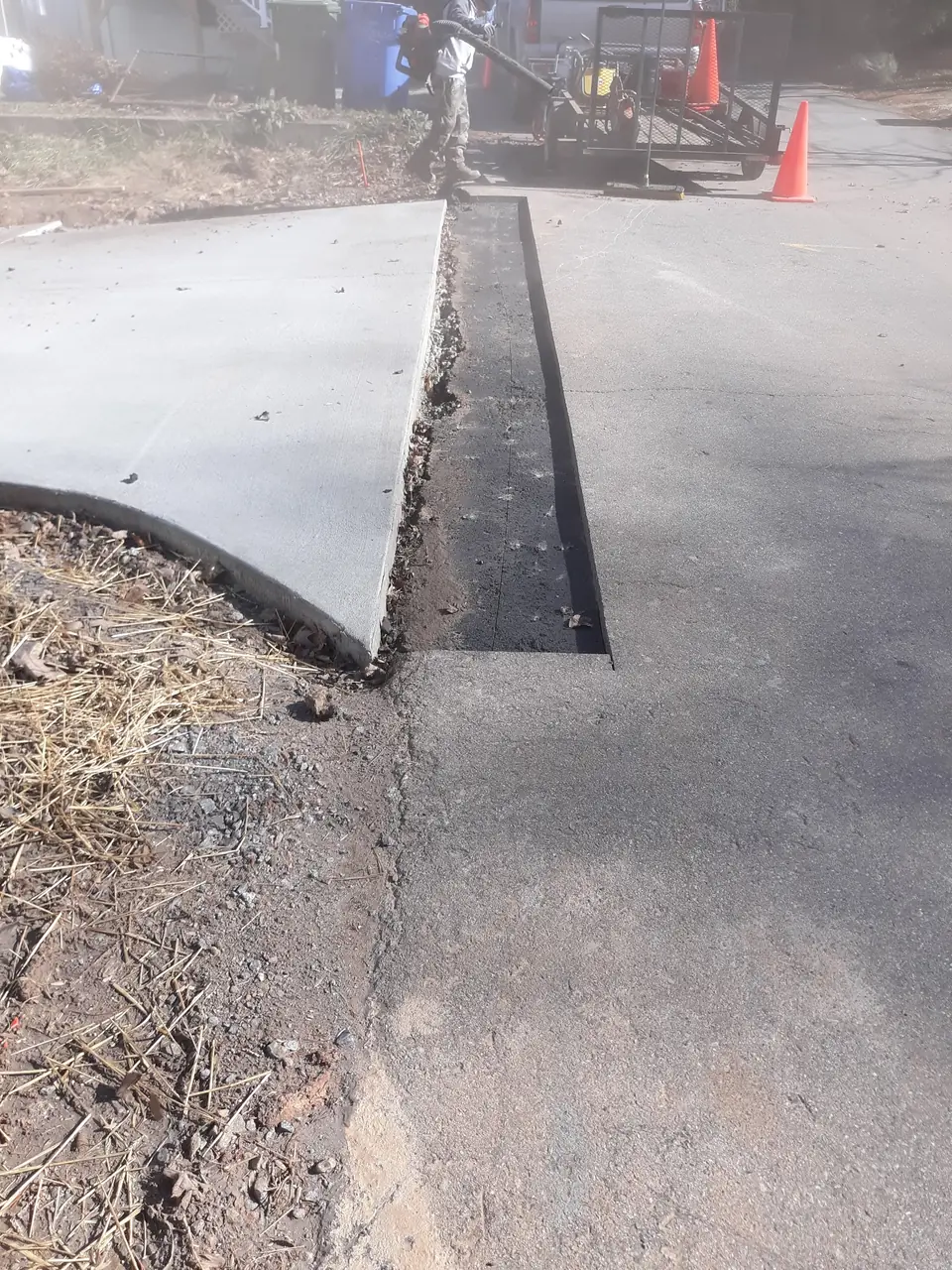 A clean saw-cut repair edge on an older driveway